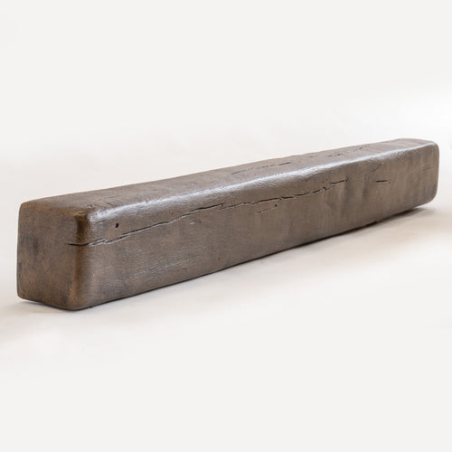 Rectangular dark brown resin beam with realistic wood grain and knot details resting diagonally on a white surface.