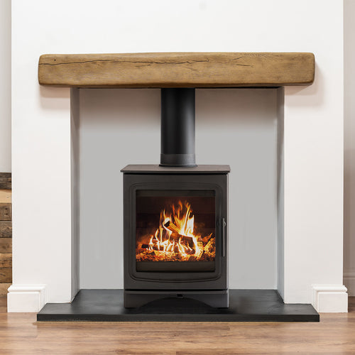 Light oak beam installed above a black woodburning stove in a white alcove